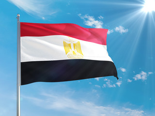 Egypt national flag waving in the wind against deep blue sky. High quality fabric. International relations concept.