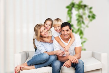Beautiful smiling lovely family sitting on sofa