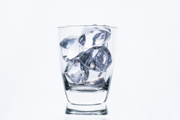 glass with ice cube isolated on white background