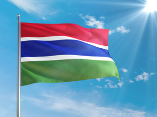 Gambia national flag waving in the wind against deep blue sky. High quality fabric. International relations concept.