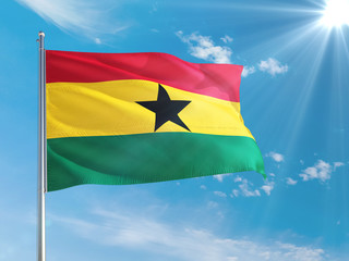 Ghana national flag waving in the wind against deep blue sky. High quality fabric. International relations concept.