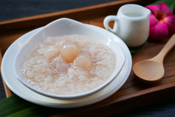 Sticky rice boiled in syrup with longan and coconut milk dressing. Thai dessert