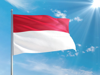 Fototapeta na wymiar Indonesia national flag waving in the wind against deep blue sky. High quality fabric. International relations concept.