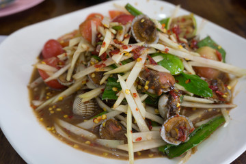 Close up Thai spicy papaya salad with cockle