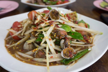 Close up Thai spicy papaya salad with cockle