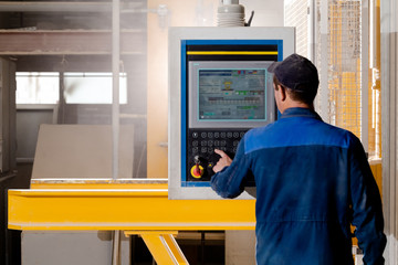 person with machine control panel