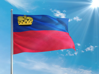 Liechtenstein national flag waving in the wind against deep blue sky. High quality fabric. International relations concept.