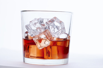 glass of whiskey with ice cubes