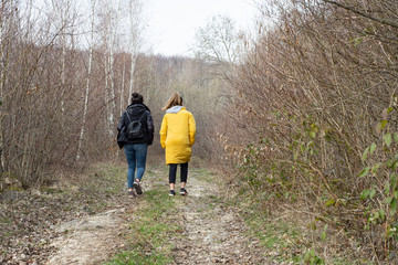 Naklejka premium Two women walking in the autumn forest