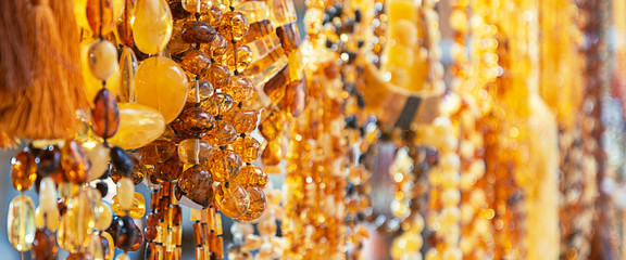 Amber beads in a jewelry store window. Jewelry design. Amber background of beads.