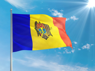 Moldova national flag waving in the wind against deep blue sky. High quality fabric. International relations concept.