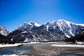 snow covered mountains with river in winter, tibet China 