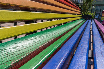 close-up of a park bench with rainbow colors