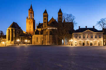 Fototapeta na wymiar Unique view of a empty Vrijthof square and no people in downtown Maastricht during blue hour with the ancient churches and former military house