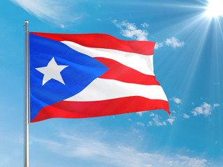 Puerto Rico national flag waving in the wind against deep blue sky. High quality fabric. International relations concept.