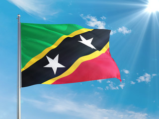 Saint Kitts And Nevis national flag waving in the wind against deep blue sky. High quality fabric. International relations concept.