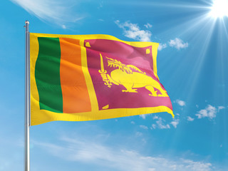 Sri Lanka national flag waving in the wind against deep blue sky. High quality fabric. International relations concept.