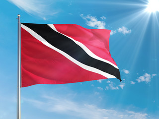 Trinidad And Tobago national flag waving in the wind against deep blue sky. High quality fabric. International relations concept.