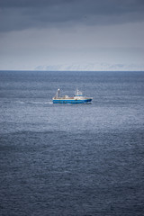 A lone fishing trawler somewhere south of Iceland in the Atlantic Ocean.