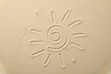 Fototapeta na wymiar Suns drawing on dry sea sand, top view