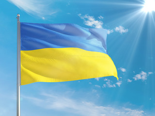 Ukraine national flag waving in the wind against deep blue sky. High quality fabric. International relations concept.