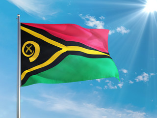 Vanuatu national flag waving in the wind against deep blue sky. High quality fabric. International relations concept.