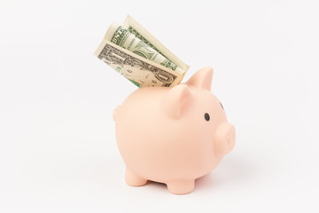 Pink piggy bank whith dollars, isolated on white background. Concept of savings