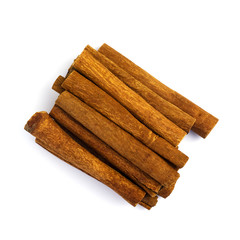 Pile of cinnamon sticks isolated on a white background. Top view.