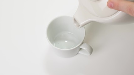 Pouring a coffee beans in white Cup. Close up.
