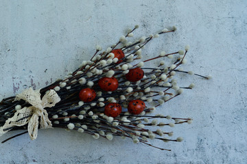 Easter composition of red eggs and twigs of a tree with flowering on light cement background. Naturally Eggs painted with onion peel.Eco paint. Happy Easter card. Flat lay.Copy space for greeting text