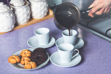 Woman hand pouring greek coffee