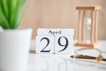 Date on white wooden cubes - the twenty ninth, 29 April 01 on a white table.