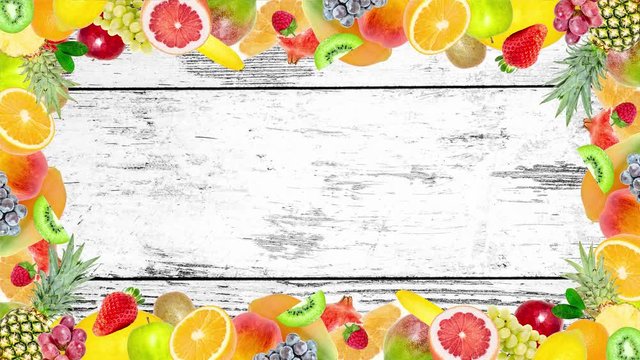 Creative 4k stop motion video animation of many different exotic tropical bright fruits frame quickly appearing and disappearing on old grunge vintage wooden background. Seamless loop.
