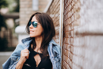 beautiful athletic woman in black clothes and glasses on the playground. Healthy lifestyle. Soft selective focus.