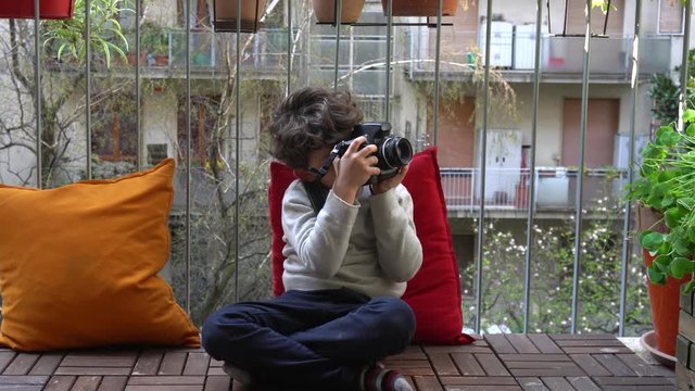 Europe, Italy , Milan - children boy  five years at home during quarantine due n-cov19 Coronavirus outbreak - life stile in apartment - taking pictures with reflex  camera - photography lesson