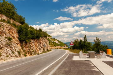 recreation area with a stone table and benches on a mountain road, Croatia