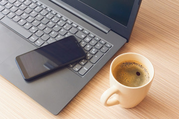 Work from home during coronavirus pandemic, mobile phone on notebook and coffee mug