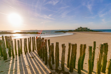 Fototapeta na wymiar break wave, Ruins of Fortress and beach of Saint Malo at low tide, Brittany, France