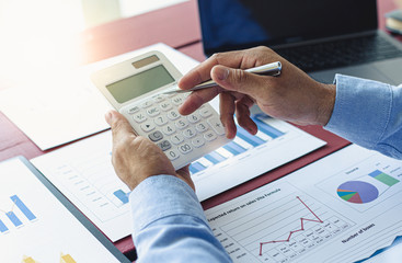 Businessmen analyze market data and calculate the cost of buying-selling products for a client's company, Professional marketing and financial accountants concept.