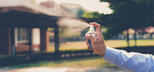 Young men use 70% alcohol spray to eliminate bacteria and viruses CORONA Or influenza COVID-19,...