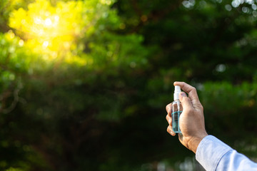 Young men use 70% alcohol spray to eliminate bacteria and viruses CORONA Or influenza COVID-19,...