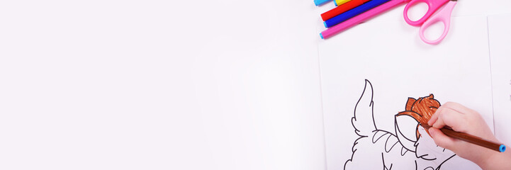 Top view white table with felt-tip pens. The child draws. Place for text.