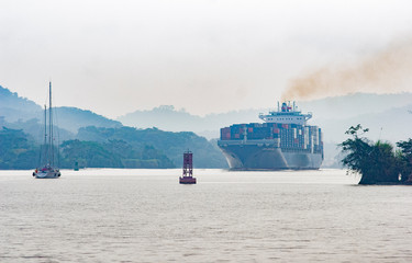 Balboa, Panama, 02-03-2020 sailing yachts and Cargo ship passing the Gatun Lake in the Panama canal
