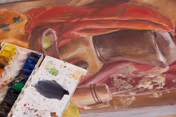 Master at work drawing made with gouache paints, still life. Paint cans and brushes hand of the master.