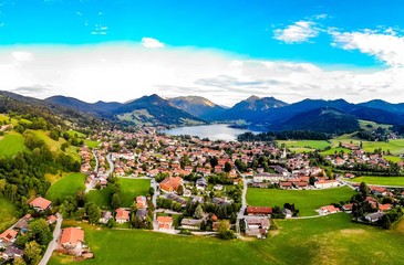 Aerial view on beautiful lake Schliersee, Bavaria, Bayern, Germany. Landscape with alps mountains, blue sky and clouds