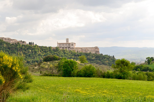 The St. Francis Church Of Assisi Seen From The Walking Path That Lead To This Little Medieval Town On The St. Francis Way Pilgrimage, A Full Immersion In Nature, Culture And History