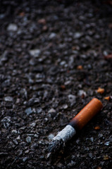 smoked cigarette on the floor