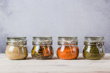 Glass boxes and bottles with quinoa, lentil, mash, pasta organized home simple stylish storage no plastic