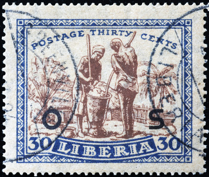 People at work on old postage stamp of Liberia