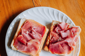 Toasts with serrano ham, traditional spanish breakfast